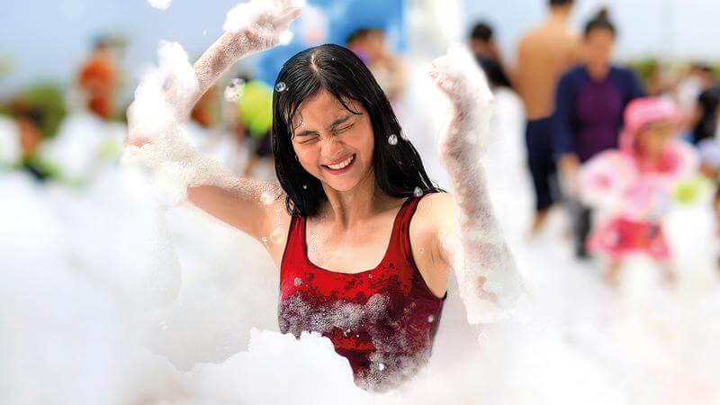 A woman having exhilarating fun at Genting Dream's onboard foam party