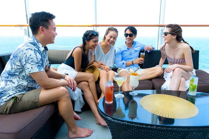 A group of friends hanging out on a Genting Dream's sundeck